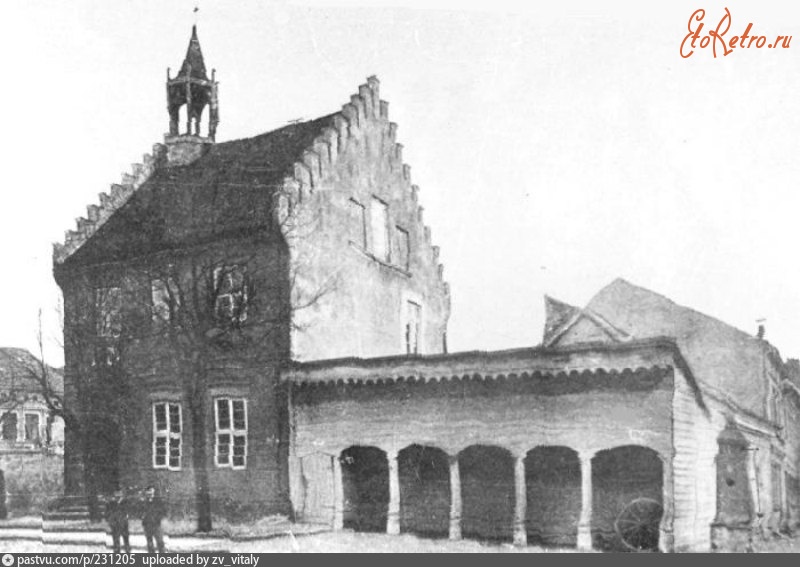 Правдинск - Alte Rathaus mit dem Kiewenschuppen und der Holzpumpe 1900—1914,