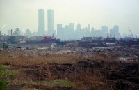 Нью-Йорк - Industrial wasteland with the World Trade Center and Lower Manhattan in the distance. США,  Нью-Джерси