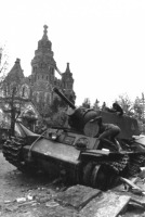Войны (боевые действия) - Немецкий солдат осматривает подбитый в Петергофе танк КВ1.